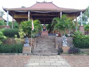a building with stairs and a flag in front of it at Eliska Sari Bungalows Sumberkima in Pemuteran