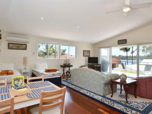 a living room with a couch and a table at Lake Macquaries' Edgewater Studio at Morisset Memories in Morisset East