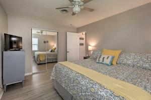 A bed or beds in a room at Bright Bungalow with Porch Walk to Ormond Beach!