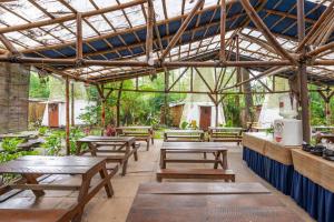 a group of picnic tables in a greenhouse at RedDoorz @ Apache Camp in Junggo