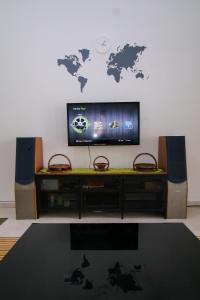 a living room with a tv and a map on the wall at Kz-COZY Homestay@D.Cemerlang in Ulu Tiram