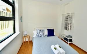 a bedroom with a bed with two towels on it at Bonnie View - a wonderful view up the river Experience Augusta in Augusta