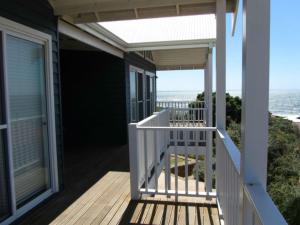 a porch of a house with a view of the ocean at Flinders View in Augusta