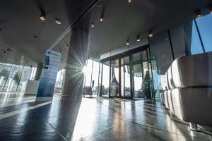 a lobby of a building with a lot of windows at Best Western Plus Net Tower Hotel Padova in Padova