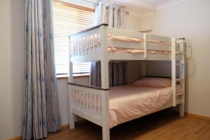 a white bunk bed in a room with a window at Sea Esta - town & beach on your doorstep in Dunsborough