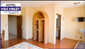 a room with a door and a room with a table at Midi Minuit in Antananarivo