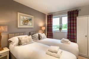 En eller flere senge i et værelse på The Penthouse @ Carus Green