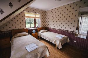 a bedroom with two beds and a window at Vanaõue in Suure-Jaani