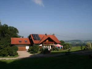 a house with a roof with solar panels on it at Ferienwohnung Angelika Neuner in Sulzberg