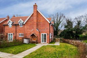 a large red brick house with a yard at 1 Roseanna Cottage, Middleton - Aldeburgh Coastal Cottages in Middleton