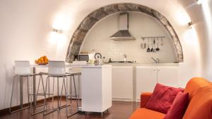 a kitchen with an archway above a kitchen counter at The House in Catania