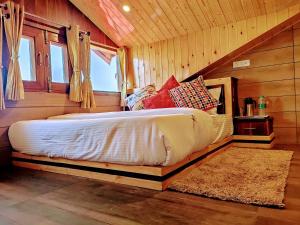a bedroom with a bed in a wooden room at Wood Stock Kasauli - Rooms & Cottages - Panoramic View & Balcony Rooms in Kasauli