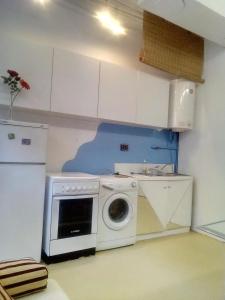 a kitchen with a washing machine in a room at Apartment Youth Vita in Zagreb