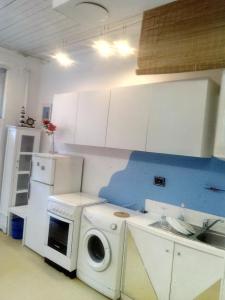 a kitchen with a washing machine and a washer at Apartment Youth Vita in Zagreb