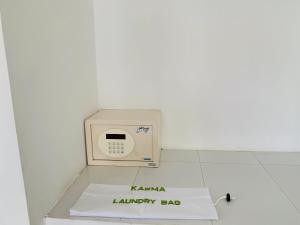 a small microwave sitting on top of a white wall at Karma Beach Resort in Kovalam