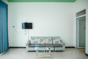 a living room with a couch and a table at Fairy Hills Hotel in Mui Ne