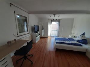 1 dormitorio con cama, escritorio y escritorio en Heumaden hell und gemütlich eingerichtete 1-Zimmer Wohnung, en Lederberg