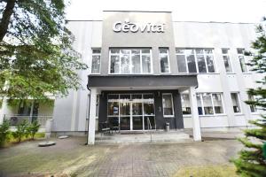 a building with a sign on the front of it at Geovita Dźwirzyno in Dźwirzyno