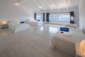 a large white room with two beds in it at Villa Koumaria in Sivota +46 photos