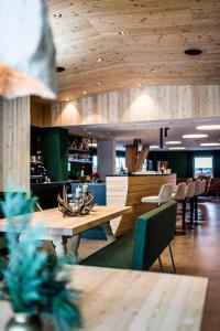 a restaurant with a wooden table and chairs at Hotel Jaufentalerhof in Racines