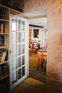 a door leading into a dining room with a table at The Pierhouse Hotel in Port Appin