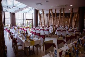 a dining room with tables and chairs and tablesktop at ASPEN GOLF RESORT Ski & Spa RELAX APARTMENT in Bansko