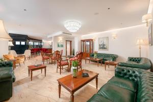 a living room with couches and tables and chairs at Hotel Cvita in Split