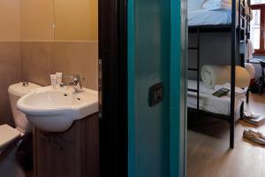a bathroom with a sink and a bunk bed at Plus Florence in Florence