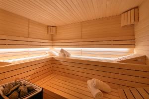 a wooden sauna with a tub with towels in it at Hotel Cvita in Split