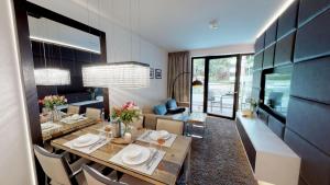 a dining room with a table and a living room at White Pearl Apartment 0.09 in Timmendorfer Strand