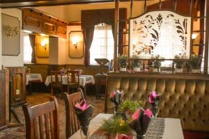 a dining room with a table with flowers on it at Park Hotel Bethlehem in Bethlehem