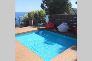 a swimming pool with two pillows sitting on a deck at DUPLEX DE CARA EL MAR 210 m2 in Tamariu