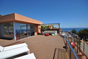 a house with a deck with a view of the ocean at DUPLEX DE CARA EL MAR 210 m2 in Tamariu