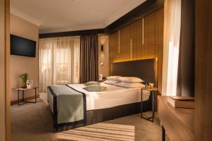 a bedroom with a large bed in a room at Rosslyn Thracia Hotel Sofia in Sofia