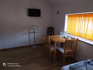a dining room with a table and chairs and a window at Břeclav centrum - U Pražáka in Břeclav