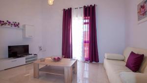 a living room with a couch and a table at Apartment close to Fort Saint Angelo in Vittoriosa