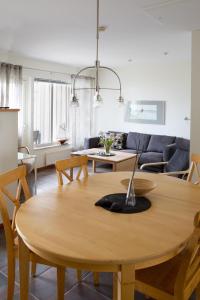 a living room with a table and a couch at Åhus Resort in Åhus