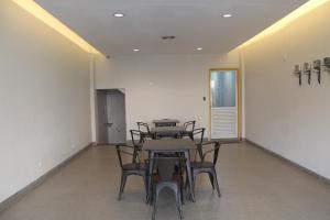a room with a table and chairs in it at Ghurfati Hotel Mangga Besar in Jakarta