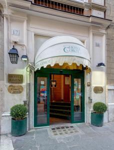 a entrance to a store with a green door at Hotel Corot in Rome