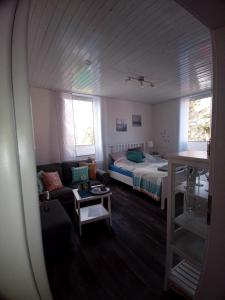 a living room with a bed and a couch at Haus Strandburg Amrum in Wittdün