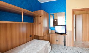 a bedroom with a bed and a television in it at La Lanterna in Silvi Marina