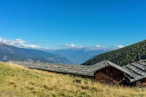 an old barn on the side of a mountain at Hotel Alpenhof in Ultimo