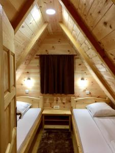 a room with two beds in a tiny house at B&B Izvor in Žabljak