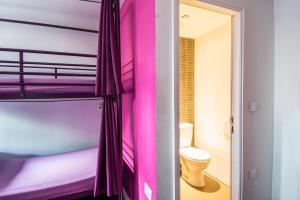 a bathroom with a toilet and a shower curtain at Safestay London Elephant & Castle in London
