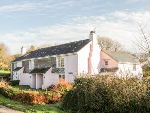 a white house with a black roof at 2 Rose Cottages in Looe