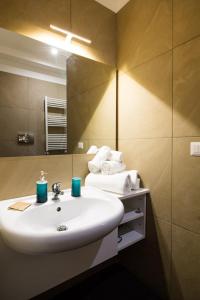 a bathroom with a white sink and a mirror at Residence Rapisardi by RECEPTIO in Catania