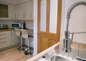 a kitchen with a sink and a faucet at Harlow apartment in Harrogate