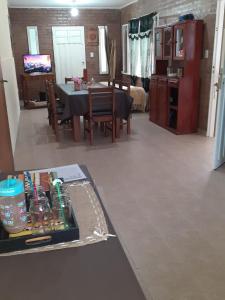 a living room with a table and a dining room at Cabaña del Río in Villa María +22 photos