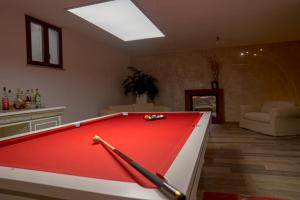 a room with a pool table with two bats on it at Depandance VILLA MASSIMILIANO in Volterra
