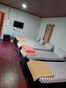 a row of beds lined up in a room at Edgestay in Mudigere